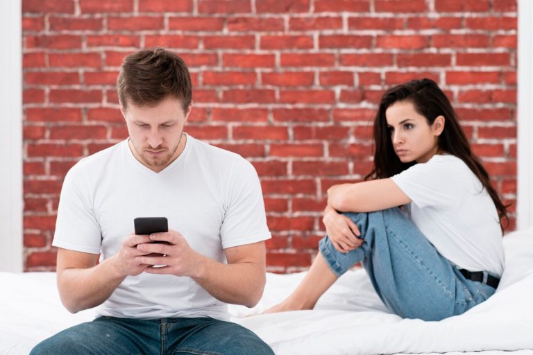 Man is cheking his girlfriend phone