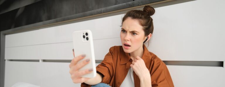 Shocked woman checking her phone.